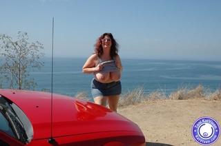 busty redhead flashes her
