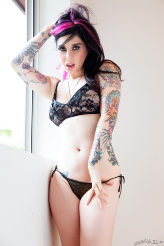 sultry tattooed vixen poses