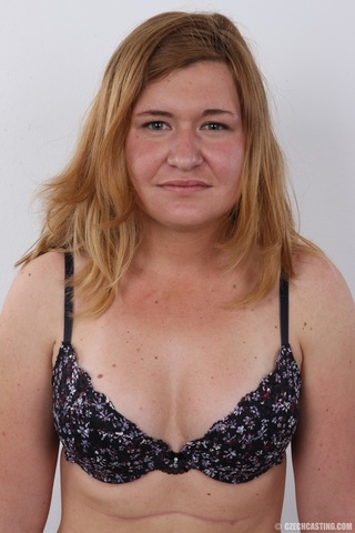 tanned blonde shyly strips